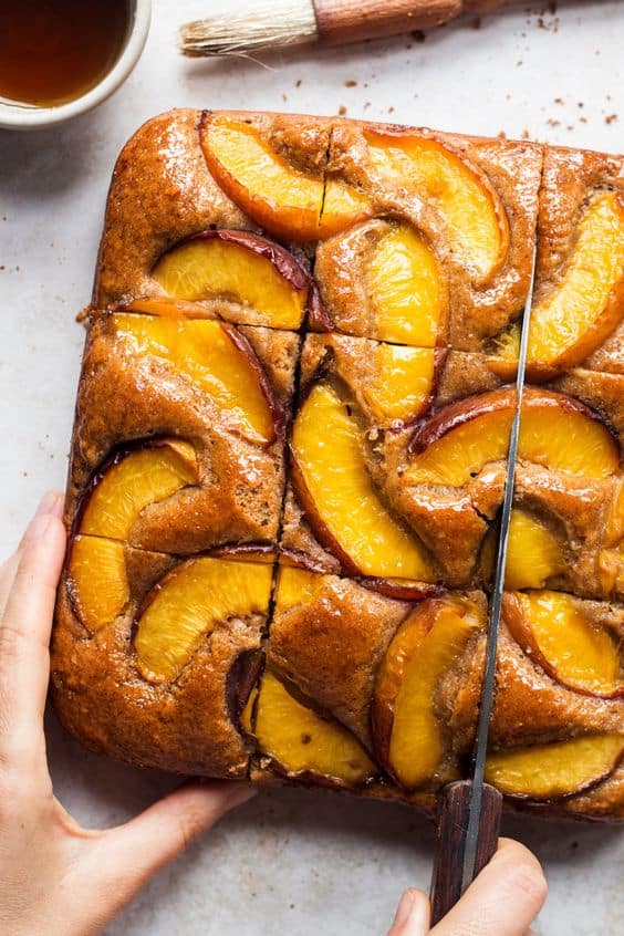 Vegan almond loaf cake, topped with nectarines.