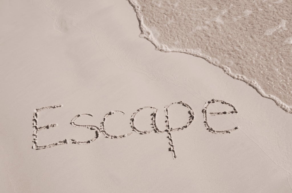 The word "escape" written in the sand of a beach - Life Without Social Media: Is It Better?